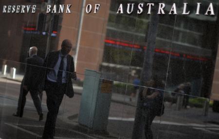 © Getty Images/AFP PHOTO/Saeed KHAN. The Reserve Bank of Australia on Tuesday announced that it will continue to hold interest rates at a record low of 2 percent. Pictured: A passerby is reflected on a wall of the Reserve Bank of Australia in Sydney on February 3, 2015.