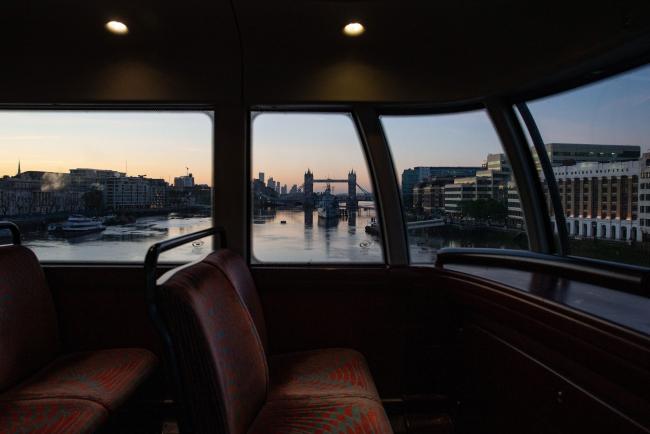 © Bloomberg. Tower Bridge stands in this view frame by a window on an empty bus traveling through the City of London, U.K., on Friday, May 29, 2020. For the last 11 weeks, Europe's financial center has been staffed with skeleton crews, particularly on the high-speed trading desks that are difficult to run from home. Photographer: Hollie Adams/Bloomberg