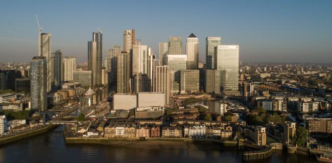 © Bloomberg. Skyscrapers housing the offices of global financial institutions, including Citigroup Inc., State Street Corp., Barclays Plc, HSBC Holdings Plc and the commercial office block No. 1 Canada Square, stand in the Canary Wharf financial, business and shopping district in this aerial view in London, U.K. on Wednesday, April. 22, 2020. U.K. inflation slowed in March as the nation entered lockdown and oil prices continued to tumble. Photographer: Jason Alden/Bloomberg