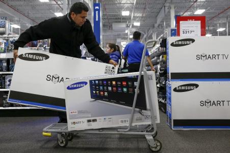 © Shannon Stapleton/Reuters. Black Friday 2015 brought shoppers looking for deals, notably on TVs and other tech. Pictured: A shopper puts televisions on a shopping cart at a Best Buy store in Westbury, New York, Nov. 27, 2015.
