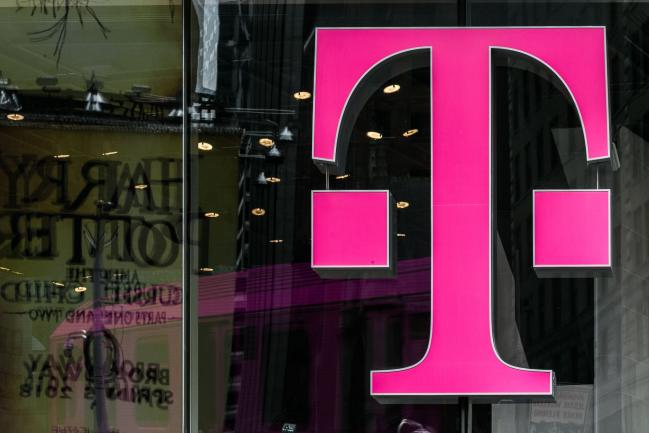 © Bloomberg. A T-Mobile US Inc. logo is displayed on a store location in New York, U.S., on Monday, April 30, 2018. Sprint Corp. suffered its worst stock decline in almost six months, rocked by fears that a proposed $26.5 billion takeover by T-Mobile US Inc. will get rejected by antitrust enforcers. Photographer: Jeenah Moon/Bloomberg