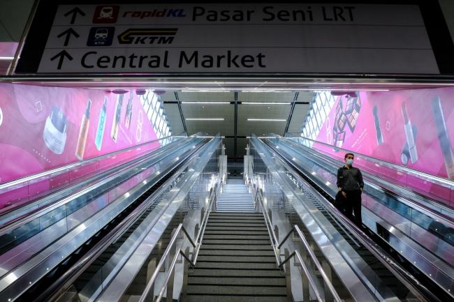 © Bloomberg. A person rides an escalator at the Central Market MRT station in Kuala Lumpur on March 18. Photographer: Samsul Said/Bloomberg