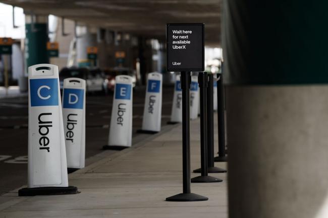 © Bloomberg. A designated waiting area for Uber ride-sharing is seen empty at San Diego International Airport in San Diego, California. Photographer: Bing Guan/Bloomberg