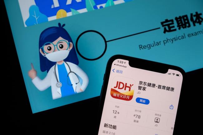 © Bloomberg. The app download page for JD Health, operated by JD.Com Inc.'s JD Health International Inc., arranged on a smartphone in Hong Kong, China, on Sunday, Dec. 6, 2020. JD Health raised HK$27 billion ($3.5 billion) after pricing Asia’s biggest health-care initial public offering at the top end of a marketed range.