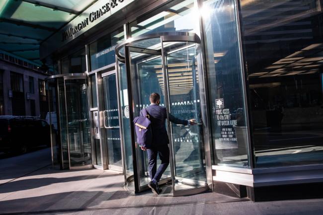 © Bloomberg. A person enters JPMorgan Chase & Co. headquarters in New York, U.S., on Monday, Sept. 21, 2020. JPMorgan CEO Dimon has made the case for a broader return, saying his firm has seen 