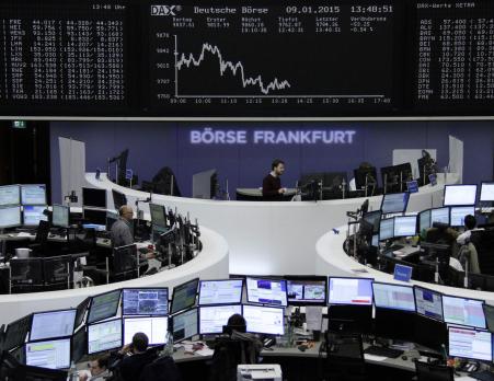 © Reuters. Traders are pictured at their desks in front of the German share price index DAX board at the Frankfurt stock exchange on January 9, 2015.Europe's markets fell Friday after Germany reported Thursday an unexpected downturn in industrial output with exports slowing.