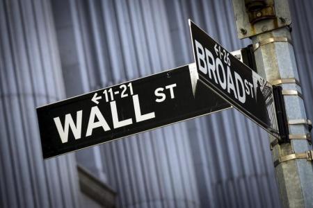 © Reuters/Brendan McDermid. Street signs for Wall St. and Broad St. hang at the corner outside the New York Stock Exchange March 24, 2015.<br/>