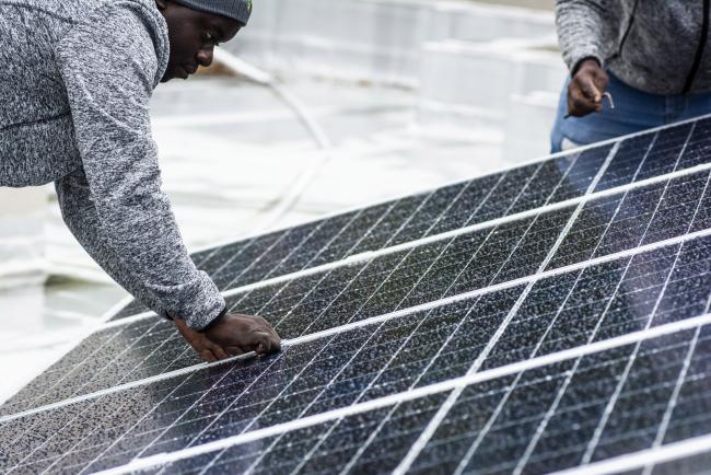 © Bloomberg. Workers install solar panels onto the roof of a residential property in Johannesburg, South Africa, on Friday, Mar. 13, 2020. The coronavirus lockdown will cause the biggest drop in energy demand in history, with only renewables managing to increase output through the crisis. Photographer: Waldo Swiegers/Bloomberg