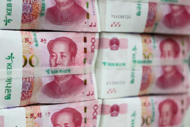 © Bloomberg. Genuine bundles of Chinese one-hundred yuan banknotes are arranged for a photograph at the Counterfeit Notes Response Center of KEB Hana Bank in Seoul, South Korea, on Friday, July 13, 2017. Yuan is set to slide for fifth week, longest losing streak since July 2016, as escalating U.S.-China trade tensions weigh on sentiment. Photographer: SeongJoon Cho/Bloomberg