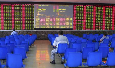 © Reuters/Aly Song. Investors look at an electronic board showing stock information at a brokerage house in Shanghai on Aug. 25, 2015.