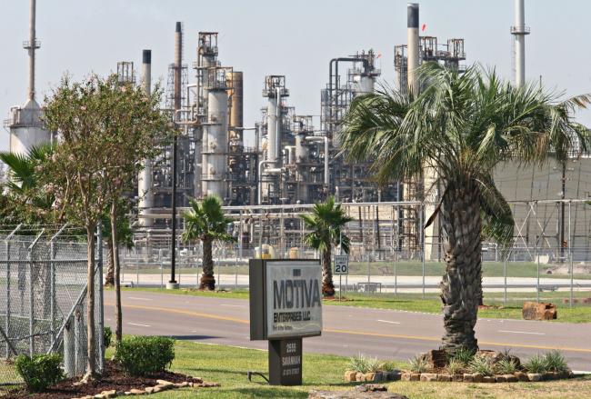 © Bloomberg. A sign for Motiva Enterprises is flanked by trees outside the Motiva refinery in Port Arthur, Texas. Photographer: Richard Carson/Bloomberg/Bloomberg