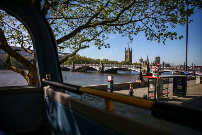 © Bloomberg. The Houses of Parliament stand in this view from inside a bus in London on April 22. Photographer: Hollie Adams/Bloomberg