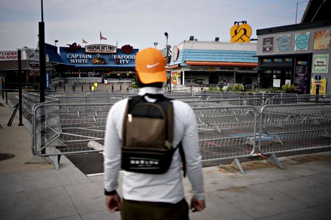 © Bloomberg. A pedestrian stands outside the temporarily closed fish market in The Wharf neighborhood of Washington, D.C., U.S., on Tuesday, April 7, 2020. D.C. has passed 1,000 cases of positive infections of coronavirus as Mayor Muriel Bowser has declared a public safety alert for the nations capital through April 24. Photographer: Andrew Harrer/Bloomberg