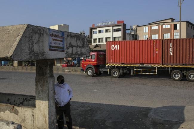 © Bloomberg. A truck transports shipping containers from the Jawaharlal Nehru Port, operated by Jawaharlal Nehru Port Trust (JNPT), in Navi Mumbai, Maharashtra, India, on Monday, March 30, 2020. As billions of people stay home in the the world's major economic centers, consumption of everything from transport fuel to petrochemical feedstocks is in freefall. Refiners that have already been filling up their storage tanks with unsold products now have little choice but to partially shut down their plants. Photographer: Dhiraj Singh/Bloomberg