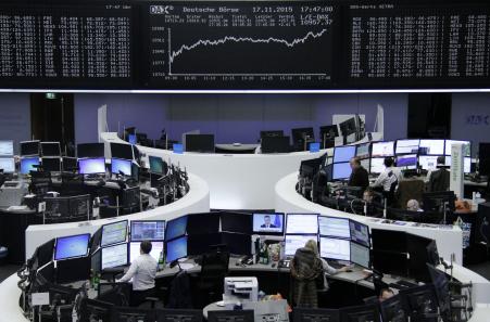 © Reuters/Staff. European markets were mixed after Mario Draghi's comments Friday. Pictured: Traders work at their screens in front of the German share price index, DAX board, at the stock exchange in Frankfurt, Germany, Sept. 29, 2015.