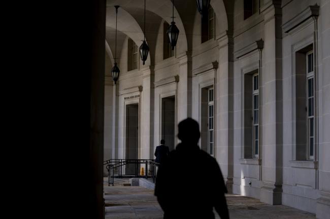 © Bloomberg. People walk past the Internal Revenue Service (IRS) headquarters in Washington, D.C., U.S., on Tuesday, April 27, 2021. President Biden and House Democrats are clashing over how much to prioritize an extension of an expanded tax credit for parents.