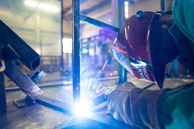 © Bloomberg. A worker welds a frame for a polycarbonate sneeze guard at the RBX Rebuilders Xchange in Cleveland, Ohio, U.S., on Monday, July 6, 2020. Plexiglass product manufacturers are reporting an increase in sales as public health experts release guidelines for retrofitting workspaces to make them safe for employees who are returning. Photographer: Dane Rhys/Bloomberg