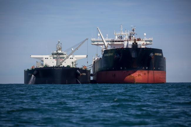 © Bloomberg. The Estrella, a crude oil tanker operated by Lundqvist Rederierna AB, left, and Nansen Spirit, a crude oil tanker operated by Teekay Corp., transfer oil between them off the coast of Southwold, U.K., on Friday, May 15, 2020. Nine tankers carrying about 5.58 million barrels of North Sea crude that loaded in April are floating off U.K. ports, according to ship-tracking data compiled by Bloomberg. Photographer: Chris Ratcliffe/Bloomberg