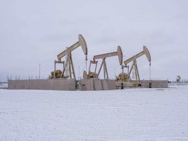 © Bloomberg. Pumpjacks operate in the snow in the Permian Basin in Midland, Texas, U.S, on Saturday, Feb. 13, 2021. The arctic freeze gripping the central U.S. is raising the specter of power outages in Texas and ratcheting up pressure on energy prices already trading at unprecedented levels. Photographer: Matthew Busch/Bloomberg