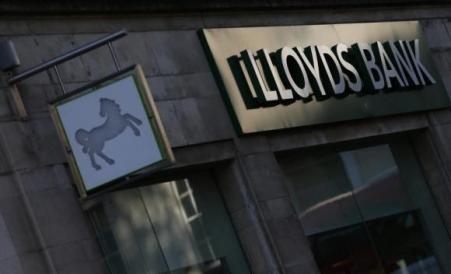 © Reuters/Andrew Winning. Signs are seen outside a branch of Lloyds Bank in central London on Oct. 28, 2014.