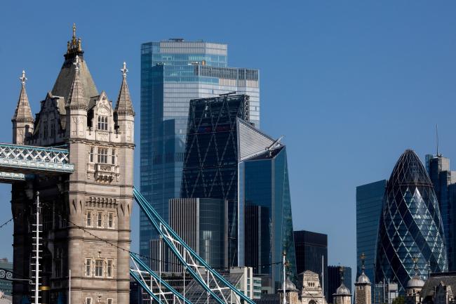 © Bloomberg. A tower on Tower Bridge stands in view of skyscrapers, including 22 Bishopgate, The Leadenhall Building, also known as The Cheesegrater, The Scalpel, and 30 St. Mary's Axe, also known as the Gherkin, stand In London, U.K., on Friday, July 31, 2020. London's best offices are forecast to plunge in value by as much as 15% this year as the coronavirus hits rents and investors' appetite for real estate. Photographer: Simon Dawson/Bloomberg