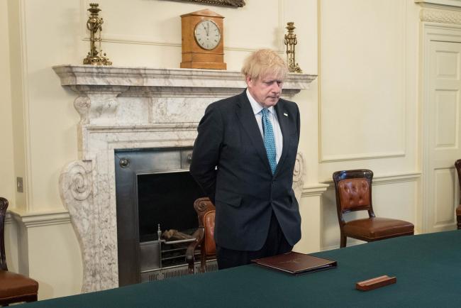 © Bloomberg. LONDON, ENGLAND - APRIL 28: Prime minister Boris Johnson, stands inside the Cabinet Room of 10 Downing Street, London, to observe a minute's silence in tribute to the NHS staff and key workers who have died during the coronavirus outbreak on April 28, 2020 in London, England. The moment of silence, commemorating the key workers who have died during the Covid-19 pandemic, was timed to coincide with International Workers' Memorial Day. At least 90 NHS workers are reported to have died in the last month, in addition to transport employees and other key workers. (Photo by Stefan Rousseau WPA Pool/Getty Images) Photographer: WPA Pool/Getty Images Europe