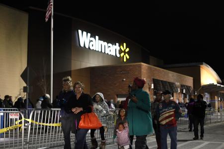 © Joshua Lott/Getty Images. Customers wait in line to enter Walmart Thanksgiving day Nov. 28, 2013, in Troy, Michigan. Black Friday shopping will look different this year as the company changes its deal strategy to simplify shopping for customers.